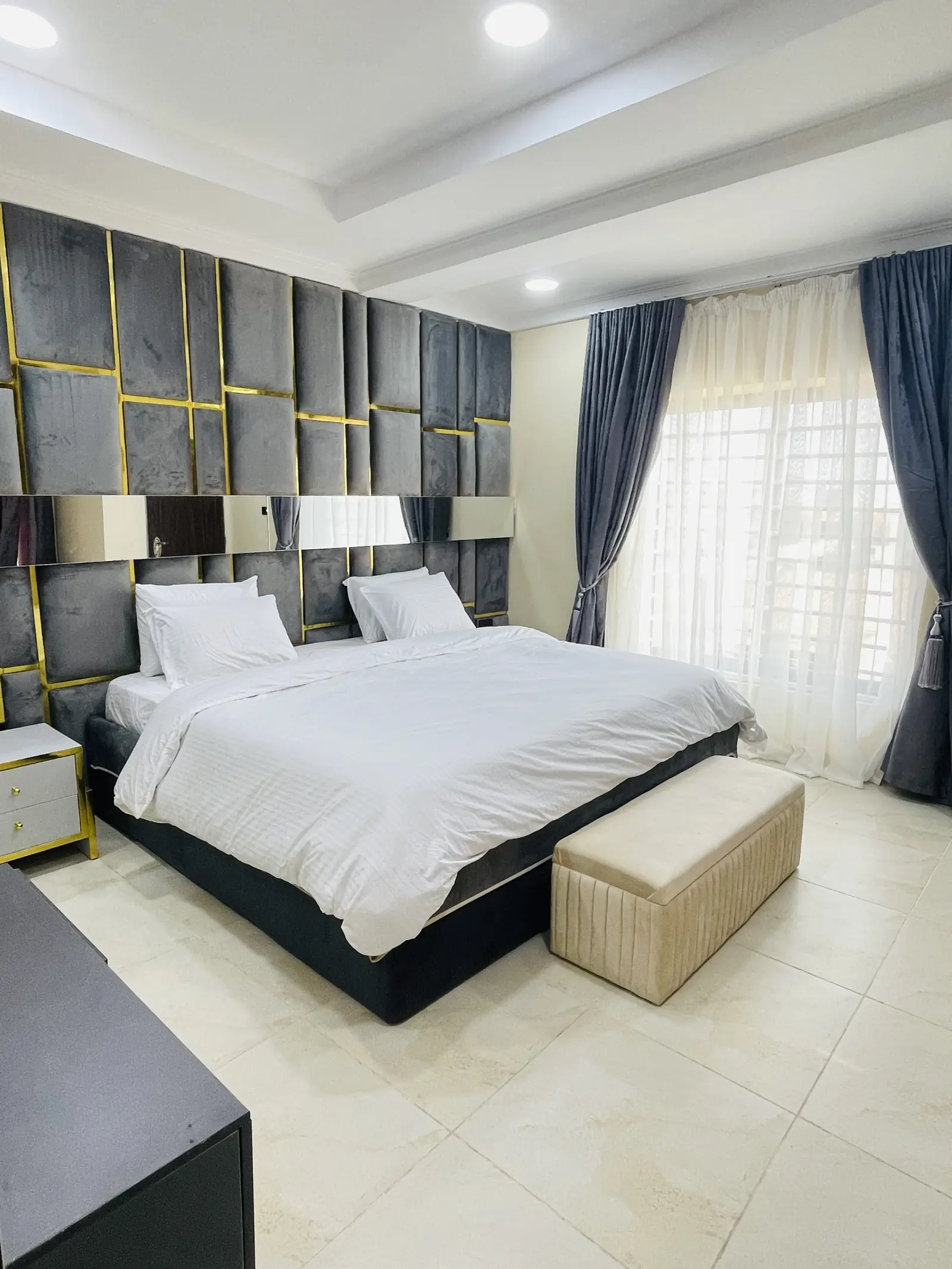 Master bedroom with upholstered panelled headboard